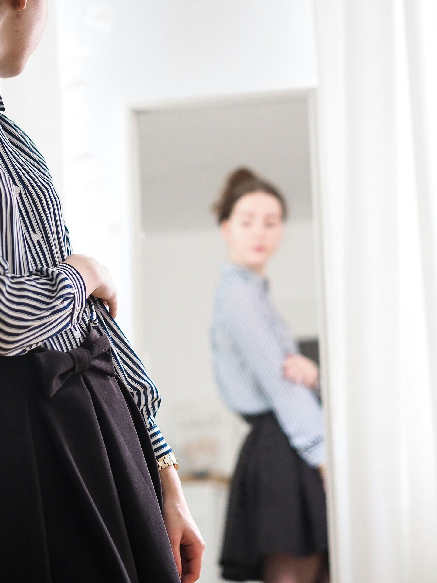 woman in black and white stripe long sleeve dress